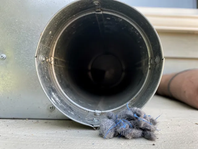 Euclid Dryer Vent Cleaning technician using specialized equipment to clear severe dryer vent blockage in Euclid